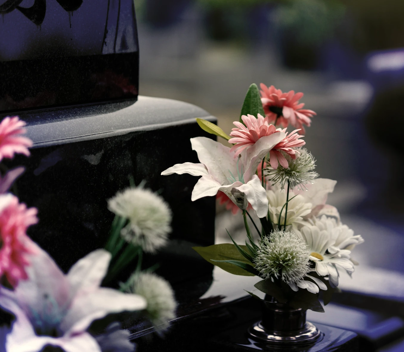 Flowers beside a polished granite memorial